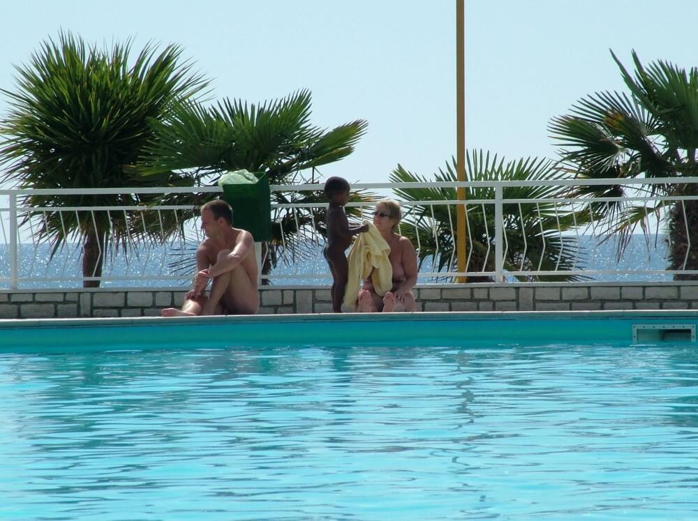 Photo of naturists in an outdoor pool - Completely naked people on planet Earth
